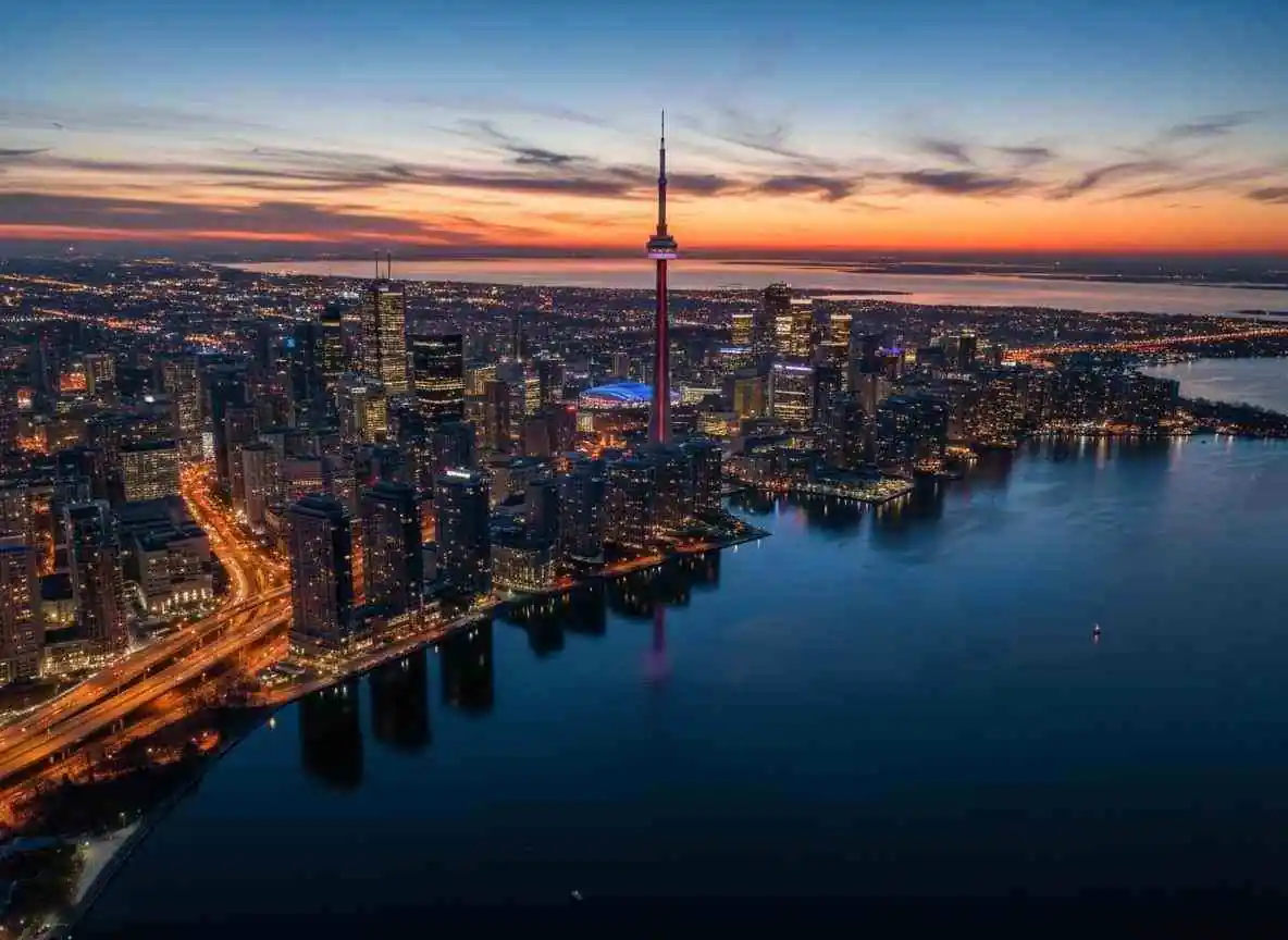 Toronto skyline at dusk with CN Tower and Lake Ontario
